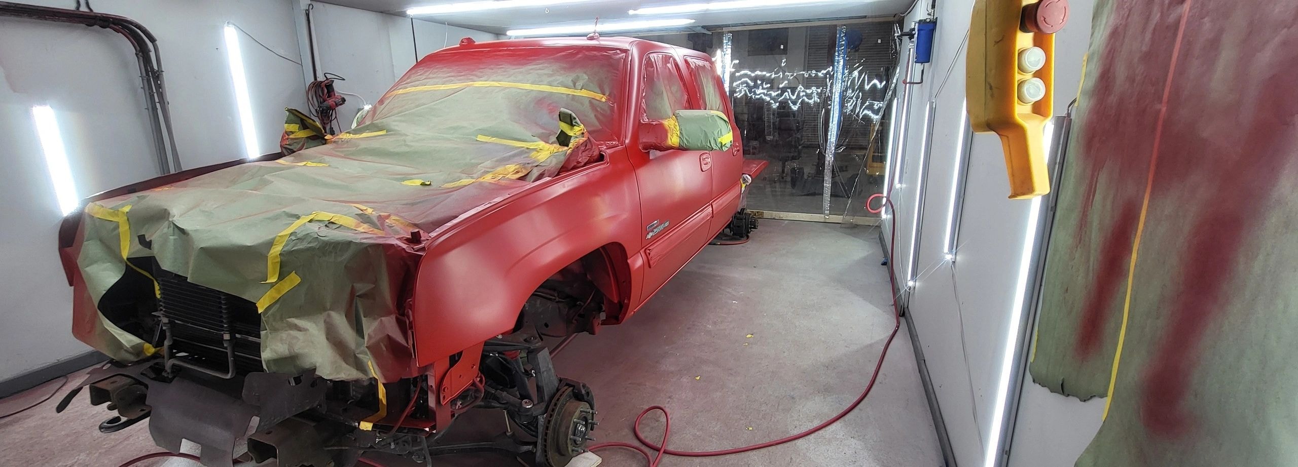 Chevy HD 2500 truck in paint booth during custom auto body painting at C.A.R.S Cartersville GA
